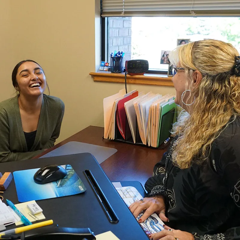 Traci Kingery meeting with a client at the agency